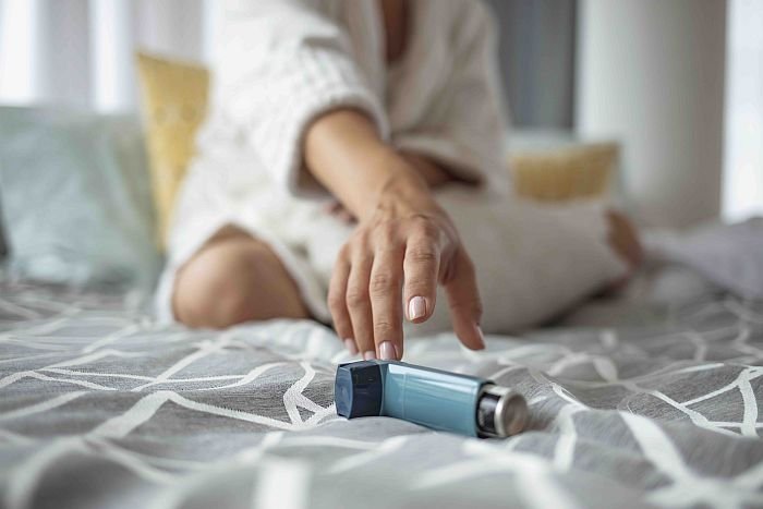 Asmathic girl catching inhaler having an asthma attack