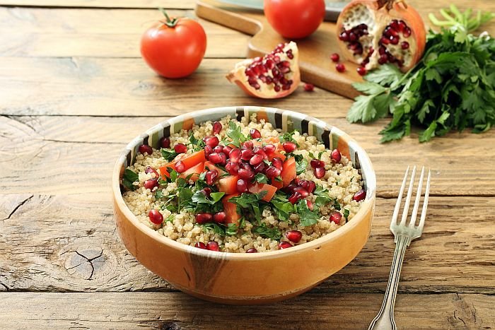 Quinoa,Salad,With,Pomegranate,On,Rustic,Kitchen,Table