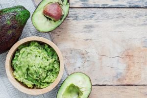 Avocado,In,A,Bowl,On,Wooden,Floor.