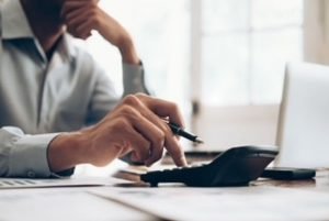 Male accountant or banker use calculator.