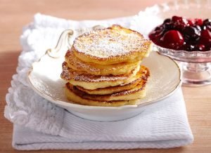 Semolina,Pancakes,With,Red,Berry,Compote,On,Crested,Plate