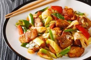 Twice Cooked Pork hui guo rou Szechuan Pork Stir Fry closeup in the plate. Horizontal